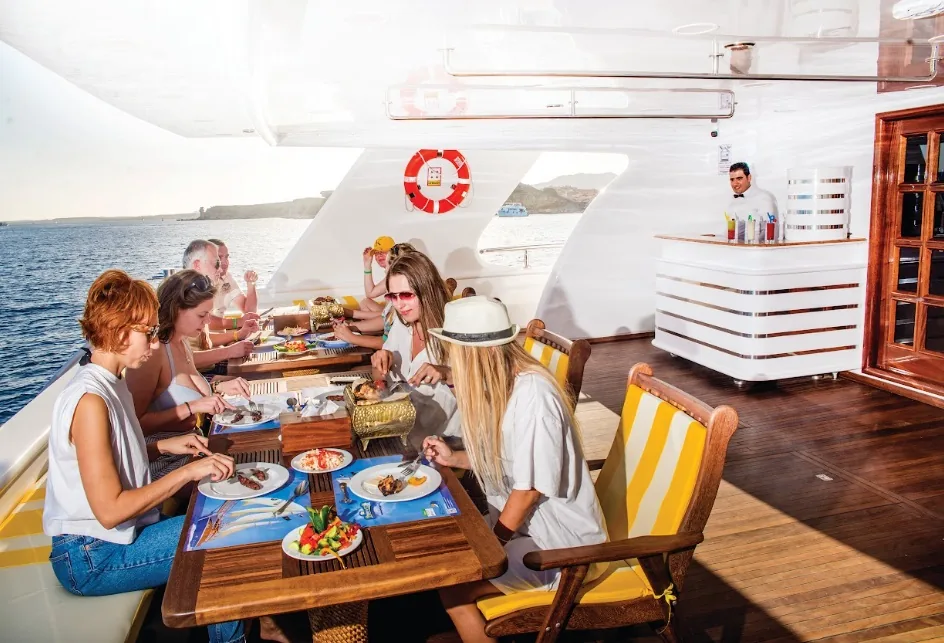 Guests enjoying an onboard yacht lunch during a Sharm El Sheikh cruise